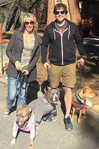 Gary the dog outside with his adoptive family - both humans and other dogs