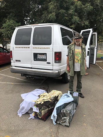 Michael with some sheet-covered live traps and a van