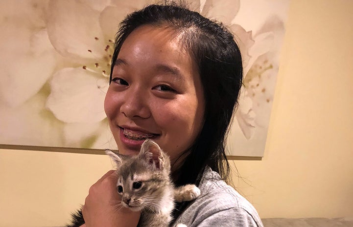 Sherry Xi holding her foster kitten Nassarose