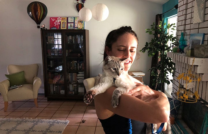 Meghan von Linden holding Knox, the Siamese FIV+ senior cat she adopted