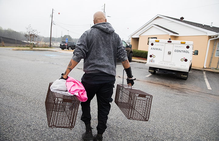 Sterling “Trap King” Davis carrying two empty live traps