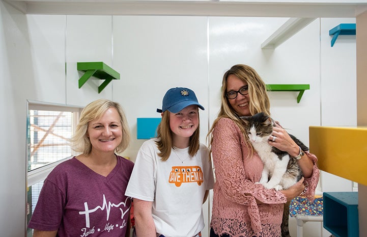 Best Friends CEO Julie Castle holding a cat, while next to Gianna Richason and another woman