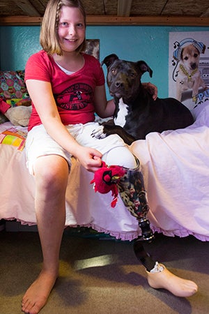 Clover the pit bull terrier who had a leg amputated makes Lydia happy