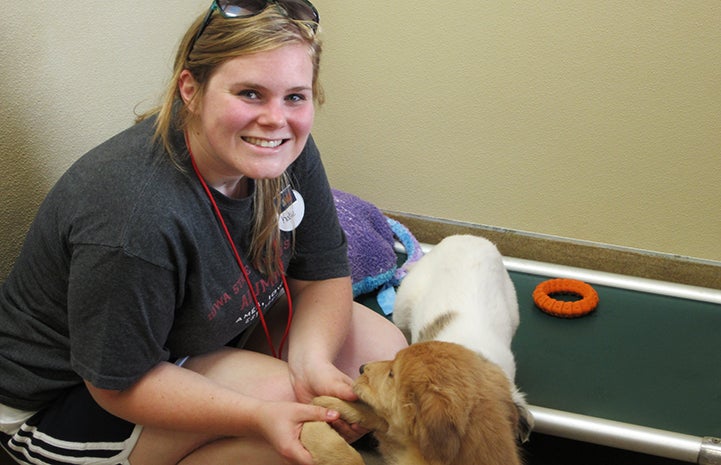 Katie Kramer Kelley volunteering with puppies at Best Friends Animal Sanctuary in 2014