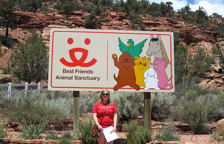 Katie Kramer Kelley in front of the Best Friends sign