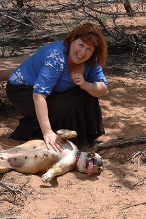 Patty Hegwood giving Ellen the Vicktory dog a belly rub