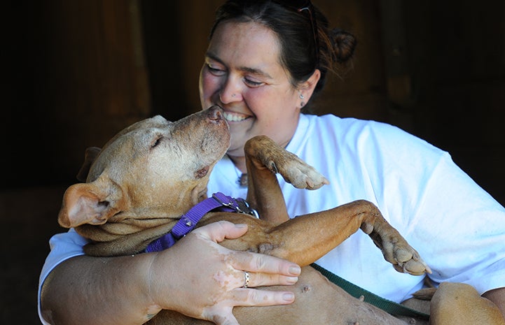 Best Friends caregiver Betsy Kidder with Little Red the Vicktory dog