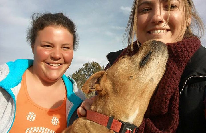 Vicktory dog Meryl giving a kiss to a woman, who's next to another woman wearing a Best Friends T-shirt