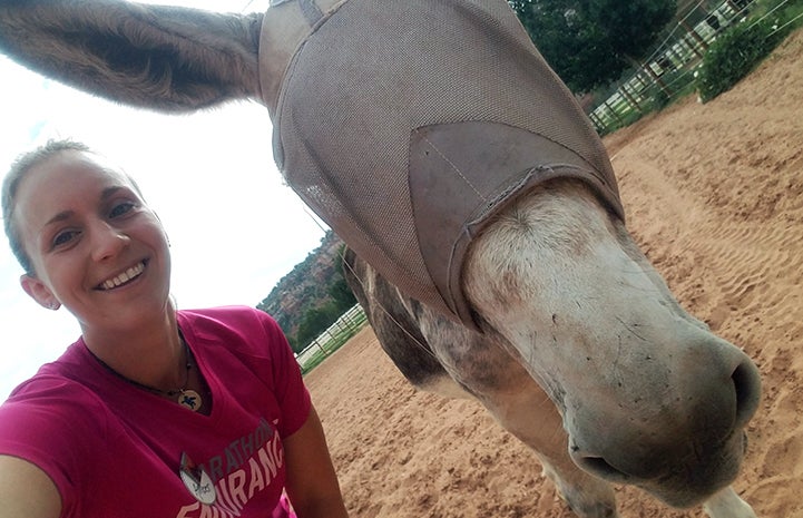 Volunteer Amber Kohnhorst with Speedy the donkey