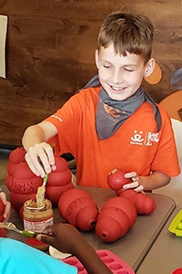 Jack Hallock at his birthday stuffing Kongs with peanut butter for dogs