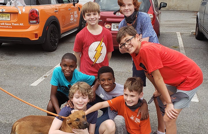 Jack Hallock and his friends posing with a dog