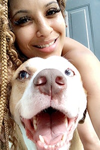 Volunteer Nisha Gross selfie with a pit bull type dog