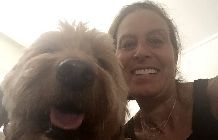 Volunteer Randi Schey selfie with a dog