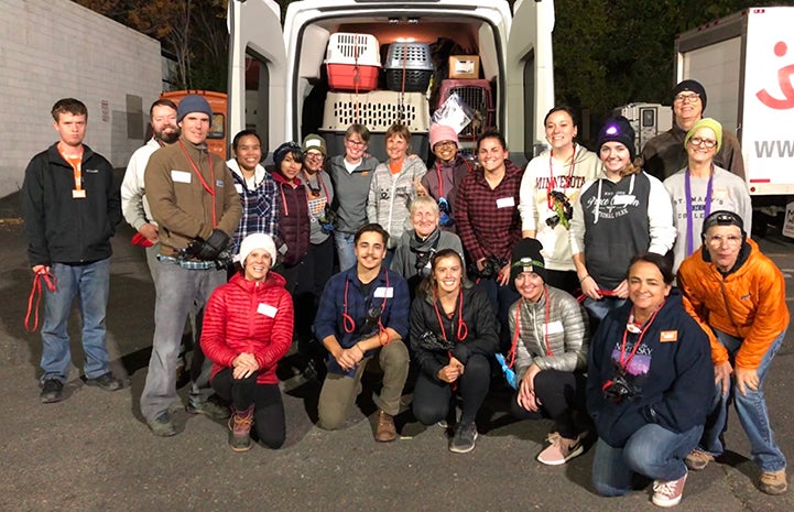 Group of volunteers posing in front of a transport van