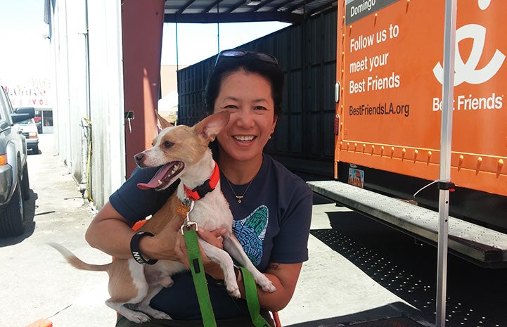 Volunteer Sophia Lim holding a puppy