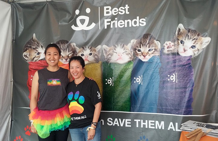 Volunteer Sophia Lim and another person standing by a Best Friends purritos sign