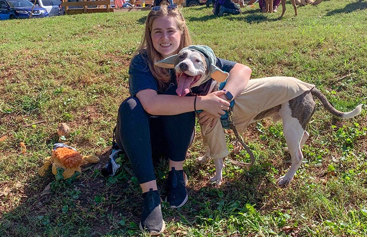 Callie with Pilsner the dog, who is wearing Baby Yoda ears