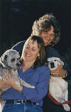 historical image of Anne Mejia and Cryus Mejia holding dogs