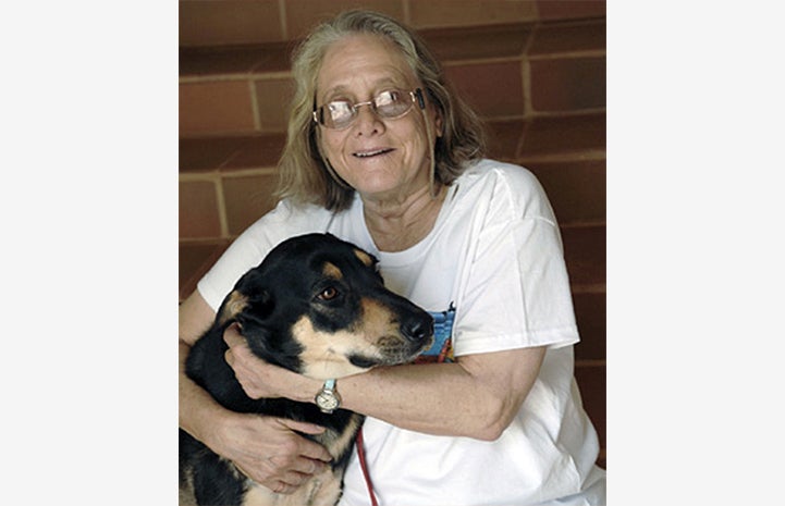 Best Friends Animal Society co-founder Claire Ives hugging a dog