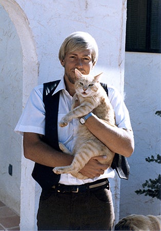 historical image of Gabriel DePeyer holding a cat