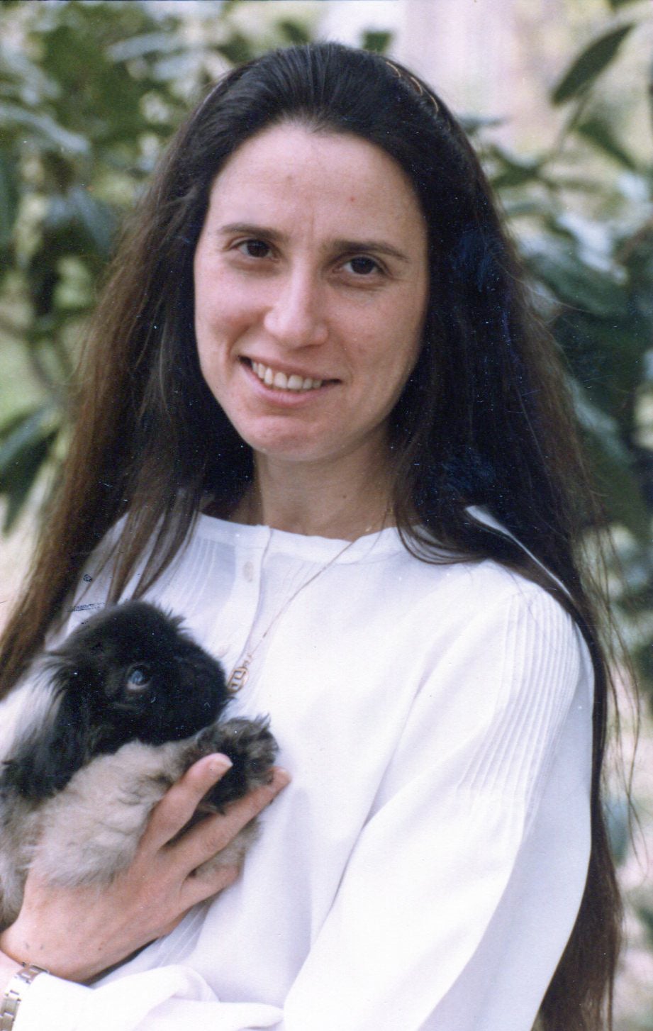 Vintage photo of Jana de Peyer holding a tiny puppy