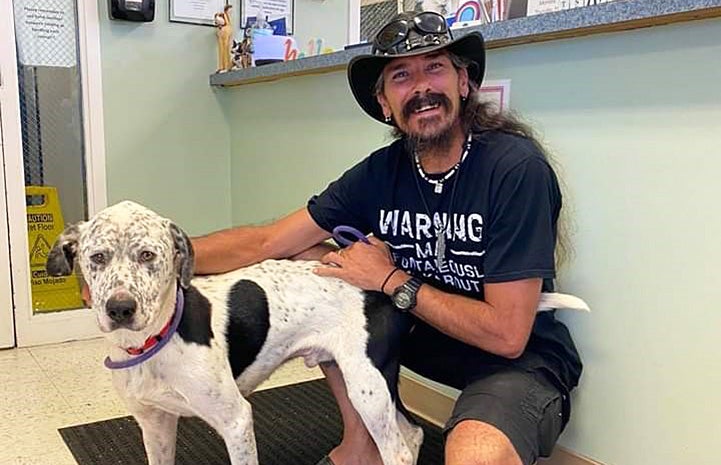 Tray Heinke with Hawkeye the dog who he helped rescue