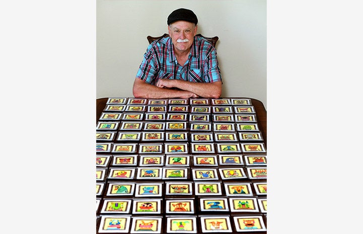 Ed Attanasio with quite a few of his 3x3 drawings