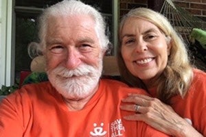 Bob and Penny Burleson wearing orange Best Friends volunteer T-shirts