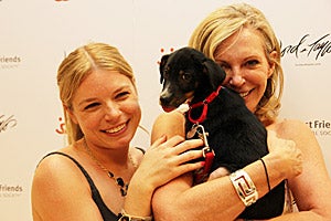 Two women holding their adopted dog