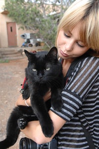 Paul Mitchell Schools student holding a cat