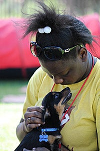 African American girl holding a small dog