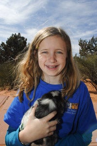 Hannah Godfrey holding a guinea pig at Best Friends Animal Sanctuary