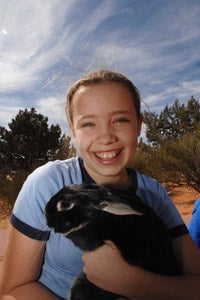 Julia Godfrey holding a rabbit at Best Friends Animal Sanctuary