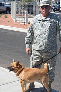 Military veteran Ted Martello walking service dog Buster
