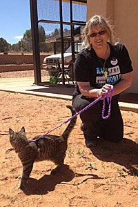Holly Gingles walking a cat at Best Friends Animal Sanctuary