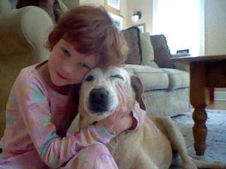 Catherine Violet Hubbard hugging a dog
