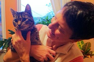 Cotton the cat with CH with his new mom at home