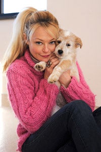 Charlotte Ross snuggling with Scone the dog