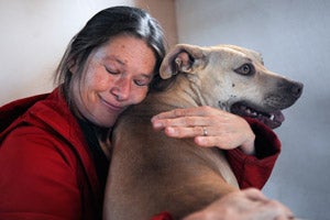 Ellen James hugs Pearl the dog