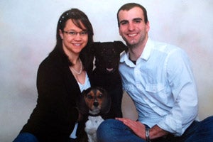 Black Labrador retriever mix Nova with his family