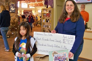 Eight-year-old Violet Schultz presenting a check to Best Friends Animal Sanctuary to help the animals