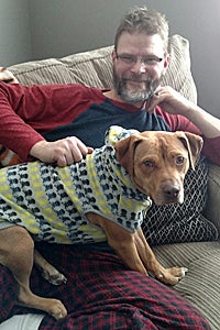 Lakota the dog rescued from a dogfighting right with his adoptive dad Steve
