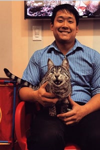 Derek Wang with eyeless silver tabby cat Ricky Bobby