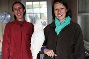 Amie Burling and Staci Cannon, two veterinary students from he University of Florida Maddie’s Shelter Medicine Program, at Parrot Garden