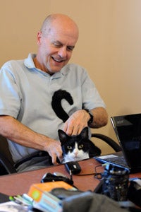 Devin the formerly distrustful cat with Dr. Frank on his lap