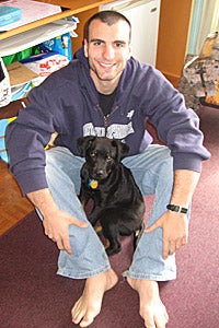 Eric with Nova black Labrador retriever mix as a puppy