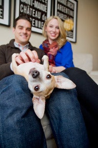 Couple with a Chihuahua dog they are fostering