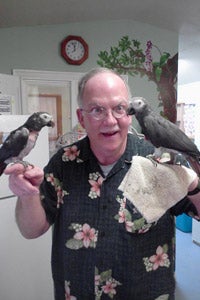 Jim with he two newest family members, two Timneh African grey parrots