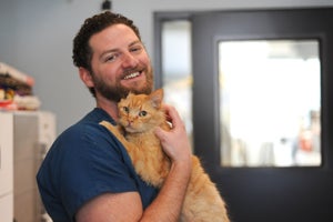 Dr. Robert Furman with Rogan the cat who just had a dental