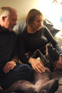 Melanie and John Dutcher, married couple volunteers, with Saydi the dog